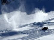 Snow cannons and grooming machines in operation