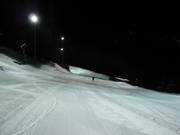 Freshly groomed night-skiing slope