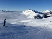 Skiing above the clouds in the ski resort of Alpe Lusia