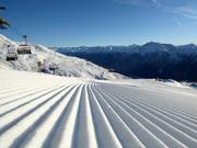 Perfect slope preparation in the ski resort of Scuol