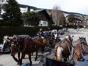 In Megève, horse drawn carriages provide a connection between lifts