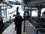 The employees load the skis onto the gondola