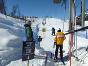 Staff supervise boarding at the button lift