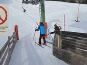 Staff hand the pole to skiers