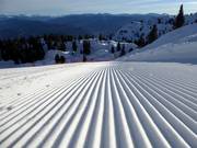 Perfectly groomed slope in the ski resort of Paganella
