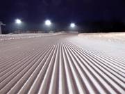 Freshly groomed slope for night-skiing