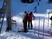 Staff hand skiers the poles at the tow lift