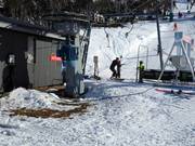 Poles are always handed to skiers at the tow lifts