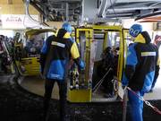 Guests are assisted when boarding the gondola lift.