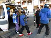 Skis are handed to guests exiting the gondola lift