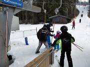 Staff hands over the T-bar at the drag lift