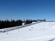 Practice slope with conveyor belt at the mountain station of the gondola lift
