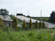 The dry ski area is located between green hills.