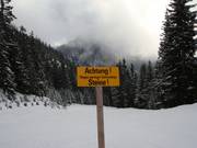 Signs warning about low snow levels