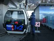 The friendly staff helps you get on the gondola lift.