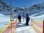 Staff is present at the entrance to the drag lift.