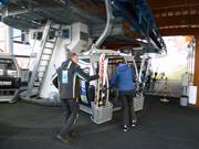 The staff assists with boarding the gondola lift.