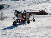 Snow cannons at the edge of the slope