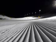 The slopes are perfectly groomed for night skiing