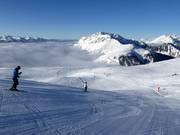 Skiing above the clouds in the Alpe Lusia ski area