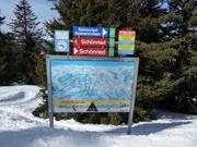 Slope signage with piste map in the ski area