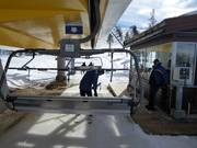 Children are assisted when boarding the chairlift.