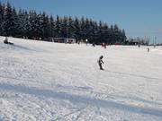Perfectly groomed slope despite a thin natural snow cover