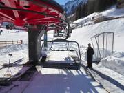 The staff assists with boarding the chairlift.