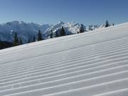 Freshly groomed slope with Kitzsteinhorn