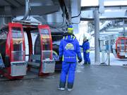 The skis are loaded onto the gondola lift.
