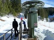 Staff assist with boarding at the button lift