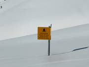 Warning signs at the edges of the slopes