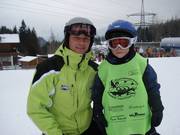 In the children's ski school, each child receives a cape with their name on it.