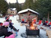 Après-ski by the open fire at the Val d'Anna Hut in St. Ulrich