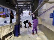 The pole is handed to skiers at the button lift