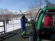 The friendly staff assists with boarding the gondola lift.