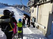 Children are assisted when getting on the platter lift.