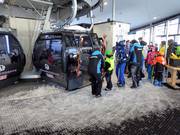 Staff assist with boarding at the gondola lift