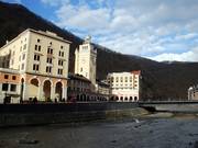 The replica of Sochi railway station towers over Rosa Square, with the Radisson Hotel in the background.