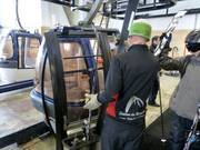 The lift attendant takes off the skis.