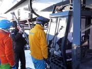 Friendly staff assist with boarding at the gondola lift