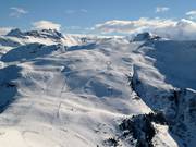 Treeless slopes and Mont Blanc in the clouds
