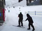 Poles are handed to skiers at the tow lift.