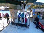 Friendly staff at the boarding area of the chairlift