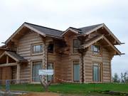 Rustic log cabins are being built next to the ski hall.