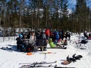 When the weather is nice, people sit in the sun.