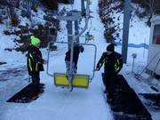 Friendly staff assist with boarding at the chairlift 