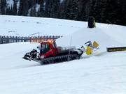Grooming of the snow park in the evening