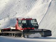 The snow groomer is waiting for its next assignment.