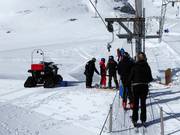 Staff hand the pole to skiers at the tow lift